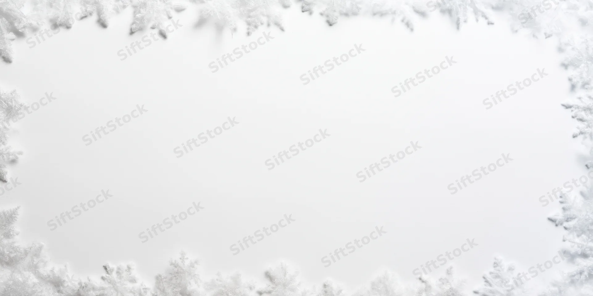 Delicate white snowflakes arranged in a border framing a blank white center