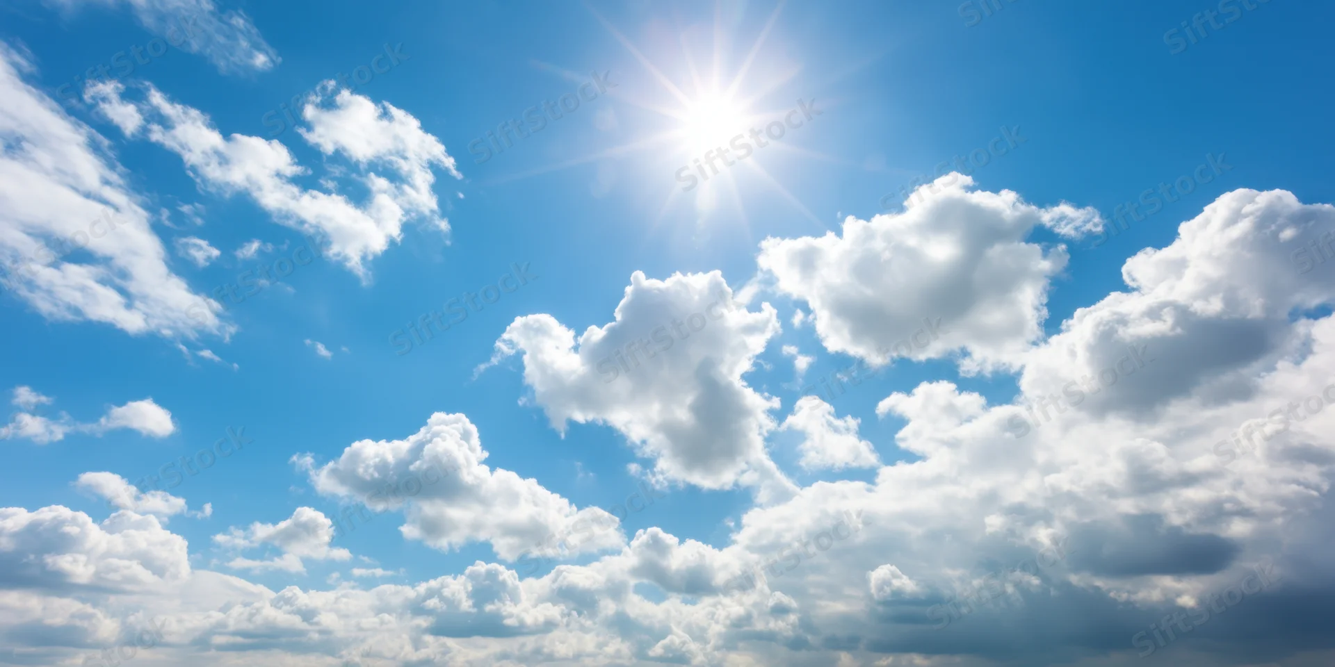 Bright blue sky with fluffy white clouds and shining sun above horizon