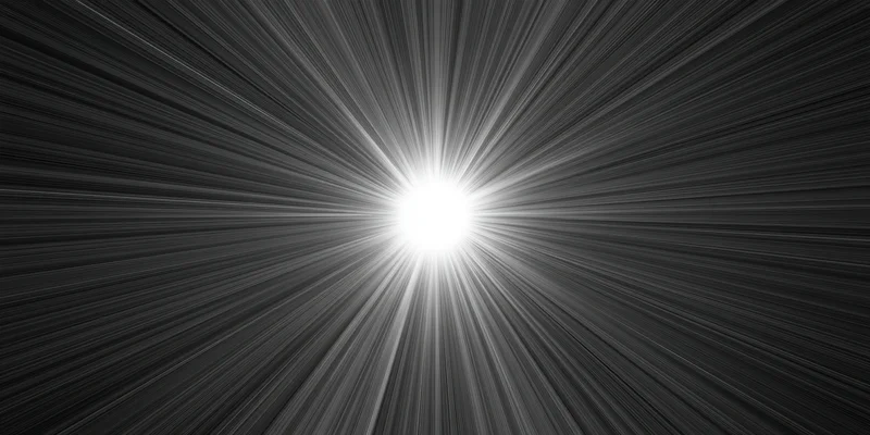 Bright white light flare with radiating rays across dark background