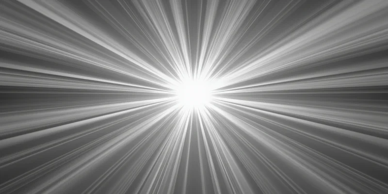 Bright light flare with radiating rays in monochrome abstract background