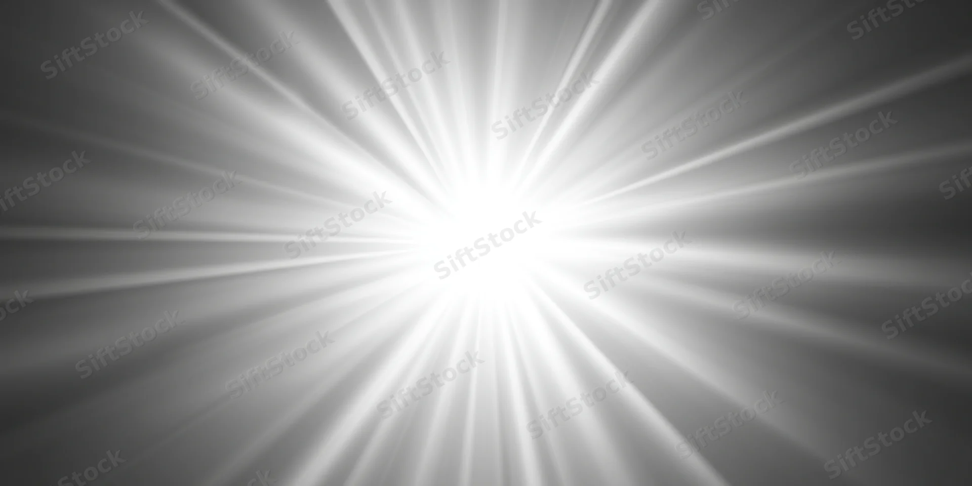 Bright light flare with radiating rays centered on a gray gradient background