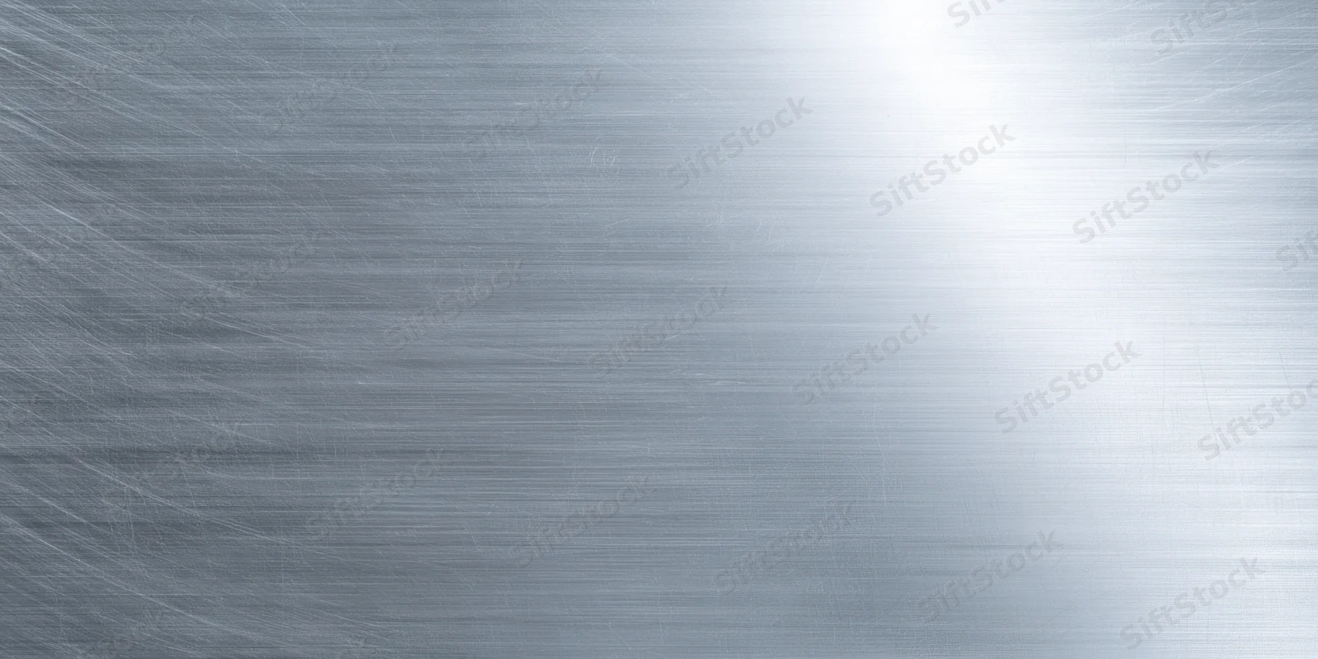 Brushed metal surface with subtle grain and soft reflect, showing a smooth reflective texture with light gradient across the frame