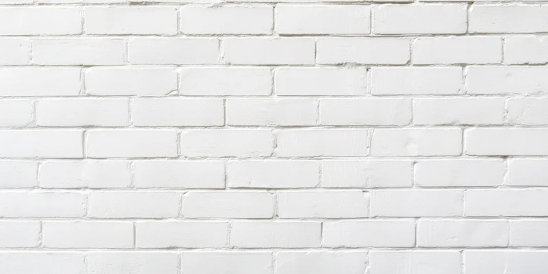 White brick wall with uniform bricks and subtle mortar lines, interior surface