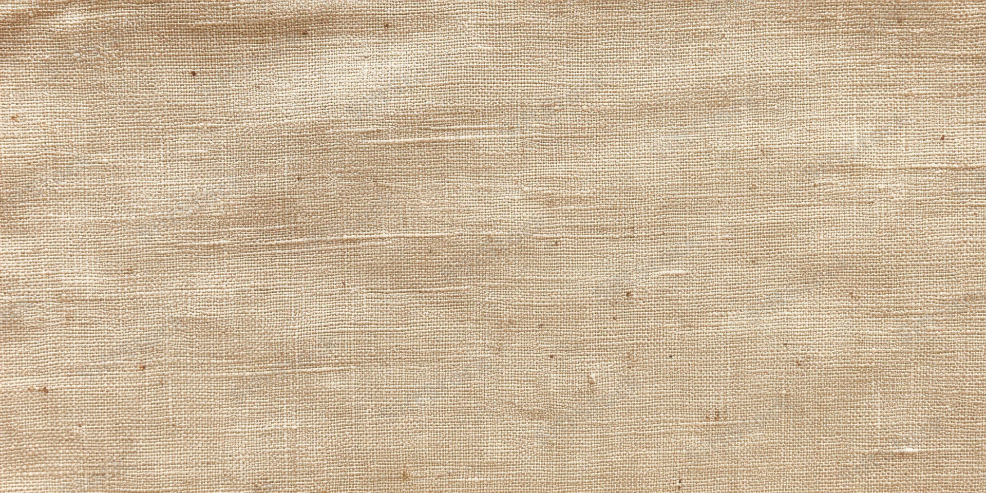 Close-up of beige linen fabric with fine woven texture filling the frame