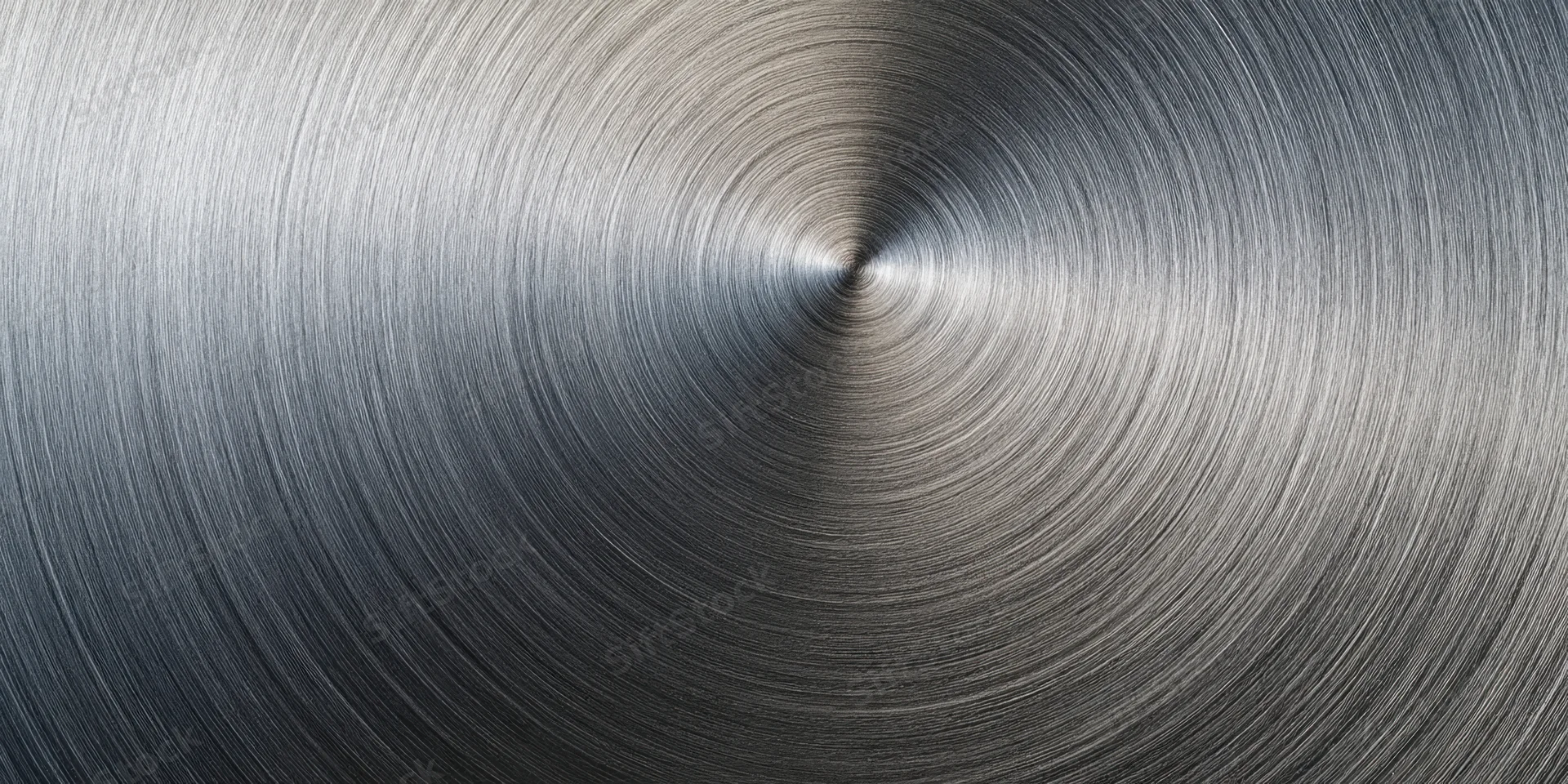 Close-up of a brushed metal surface with circular radial texture