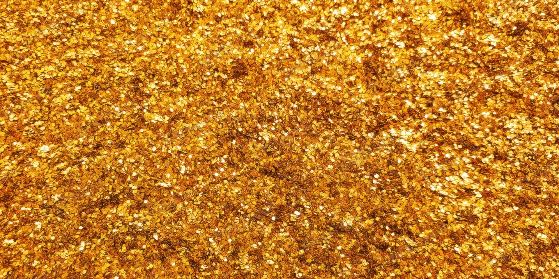 Close-up of gold glitter texture with shimmering sequins covering the entire frame