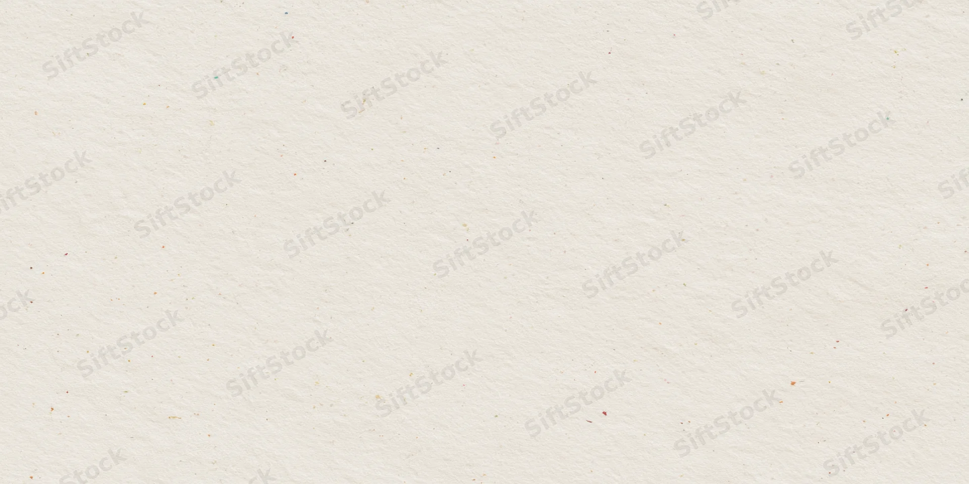 Close-up of textured off-white paper surface with visible fibers and speckles