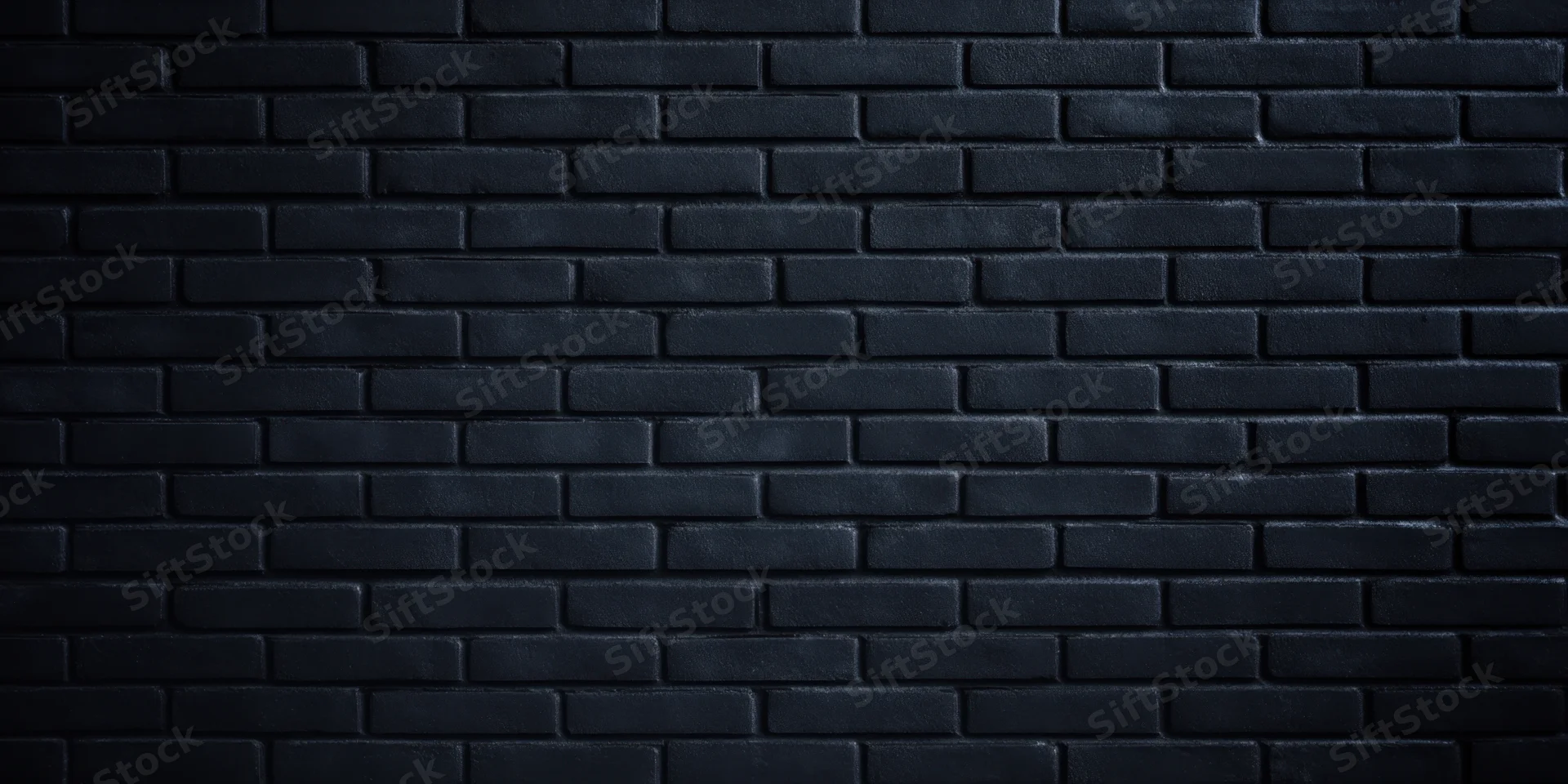 Dark brick wall with even low lighting and subtle texture filling the frame