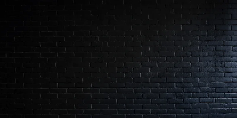 Dark brick wall with subtle texture under even low lighting