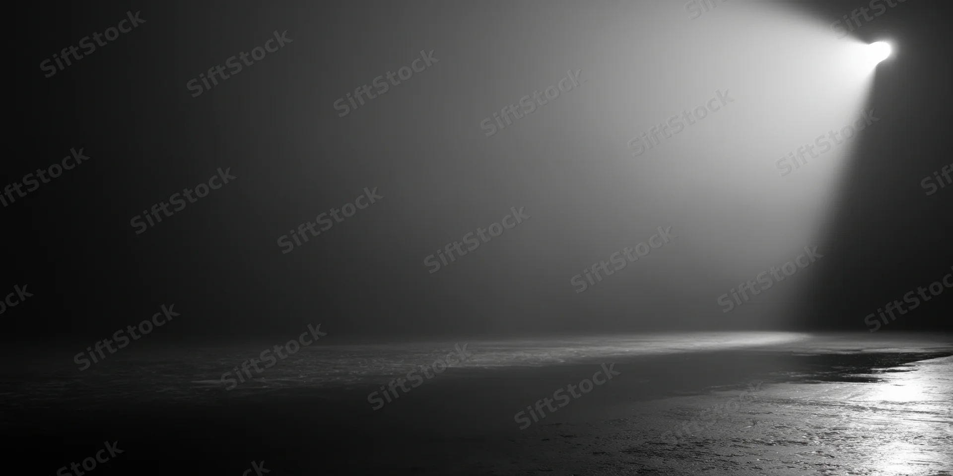 A single beam of light cuts through thick fog on a dark stage