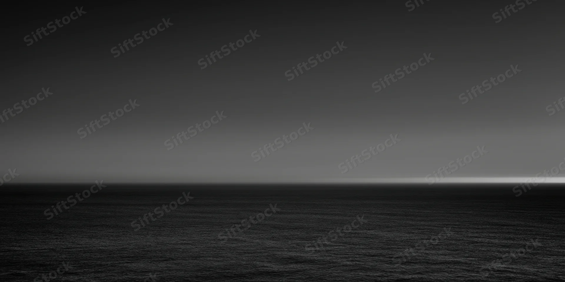 Calm expansive ocean under a gradient sky at dusk