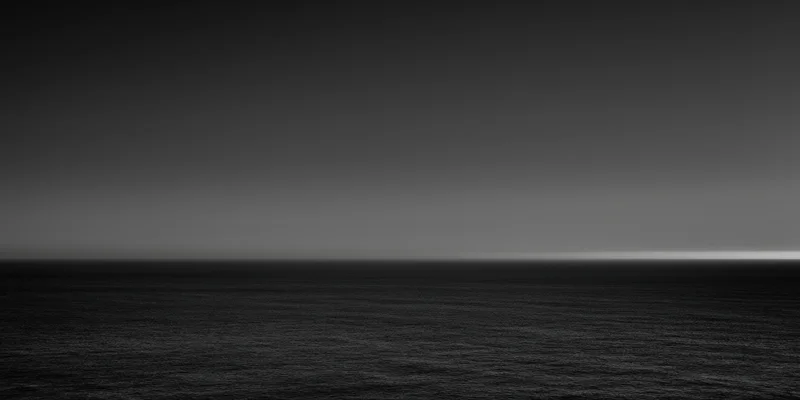 Calm expansive ocean under a gradient sky at dusk