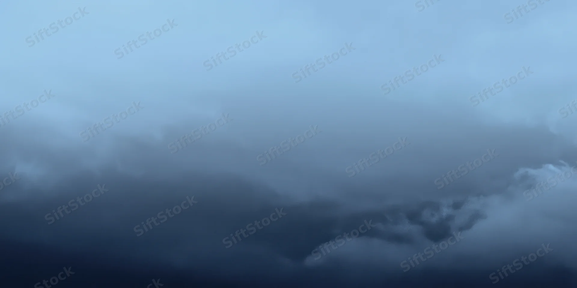 Moody blue sky with wispy clouds and soft gradient atmosphere