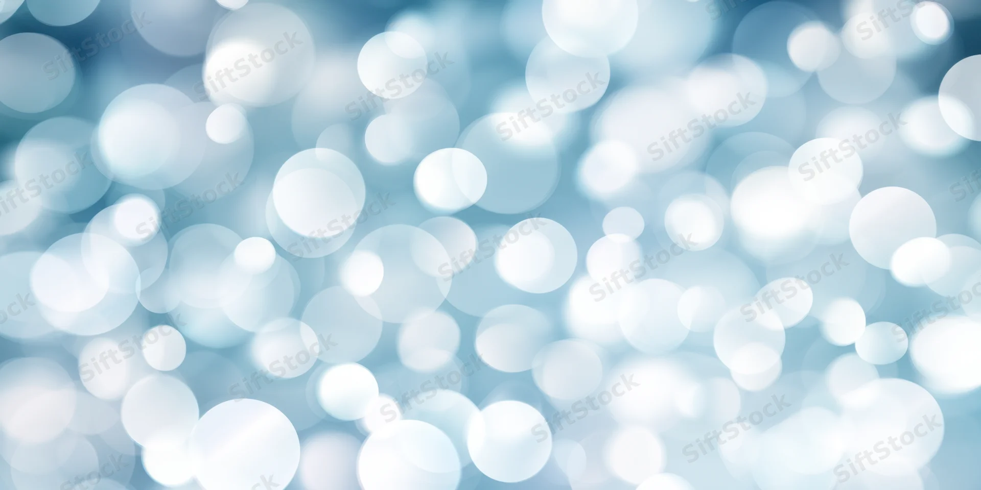 Soft blue and white bokeh lights arranged in a blurred circular pattern as a background