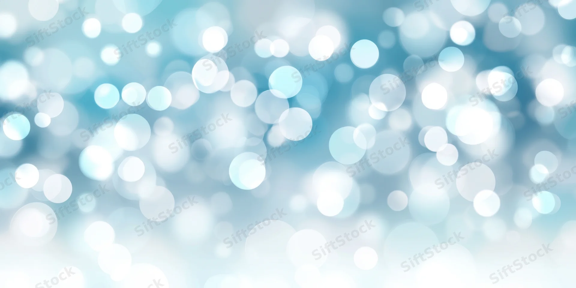 Soft blue and white bokeh lights arranged in a blurred abstract background