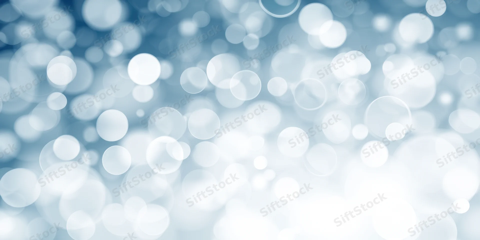 Soft blue and white bokeh lights arranged in a blurred abstract background