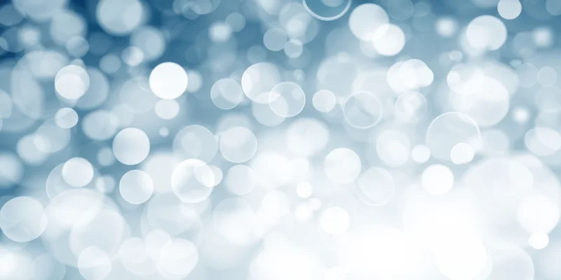 Soft blue and white bokeh lights arranged in a blurred abstract background