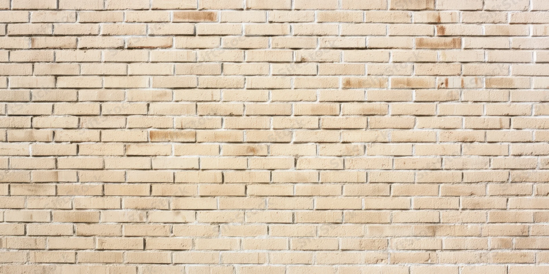 Light beige brick wall with subtle weathering and uniform pattern covering the frame