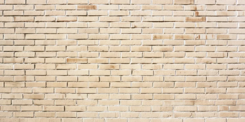 Light beige brick wall with subtle weathering and uniform pattern covering the frame