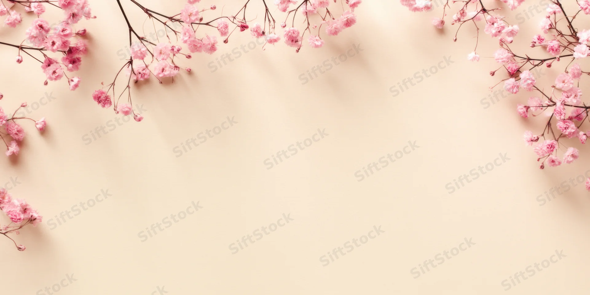 Cherry blossom branches arranged in a border on a beige background with copyspace in the center