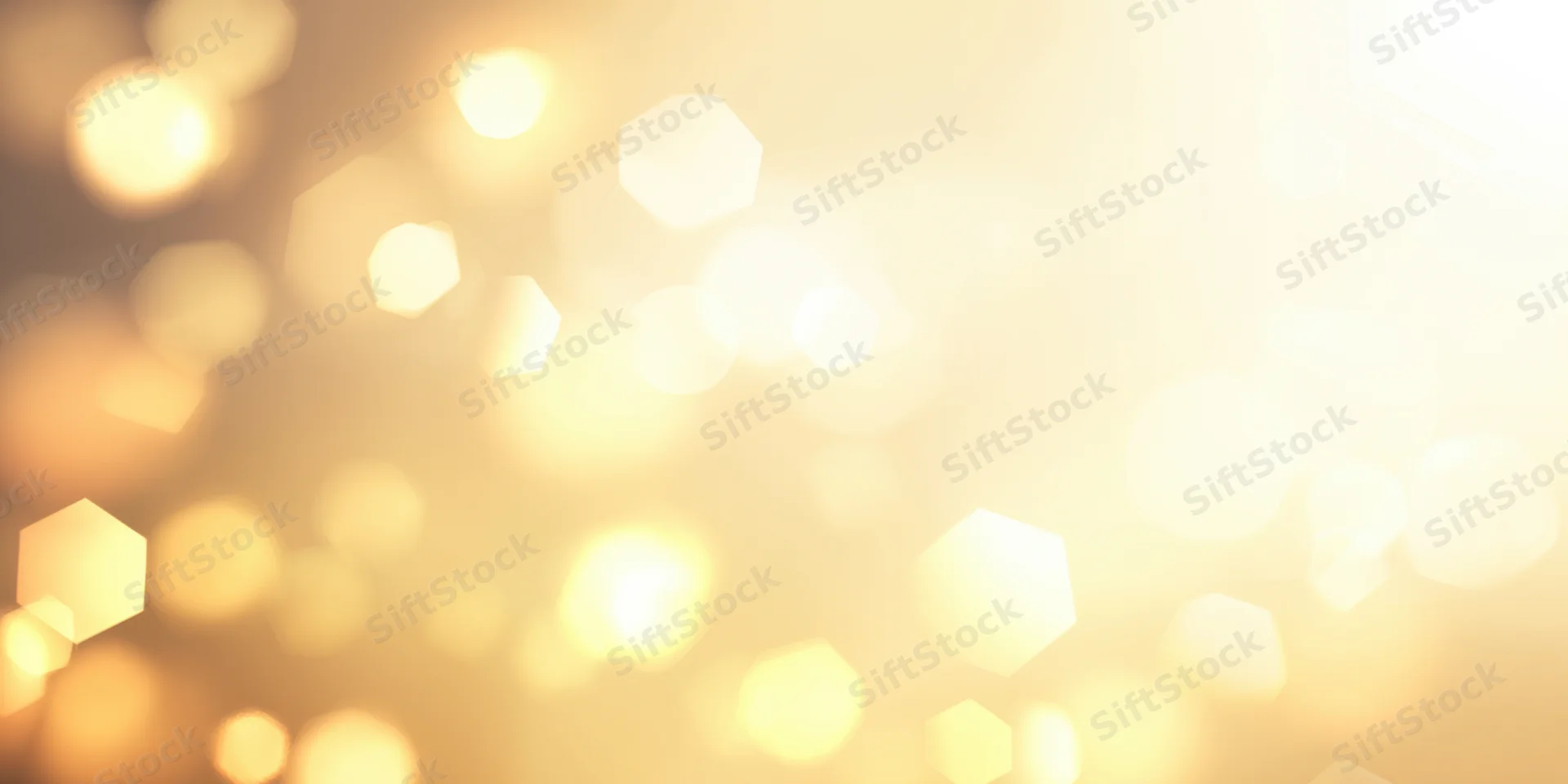Warm golden bokeh lights in soft focus creamy gradient background