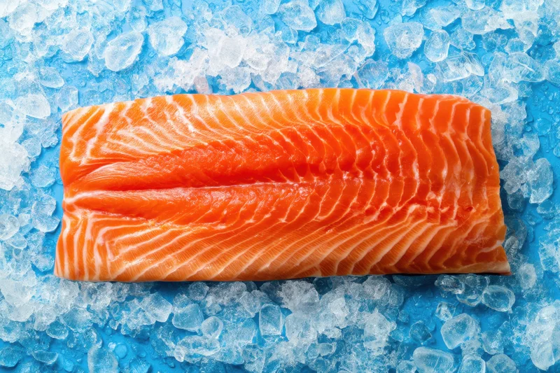 Fresh salmon fillet resting on crushed ice