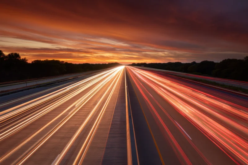 Light trails from vehicles moving on a highway at dusk