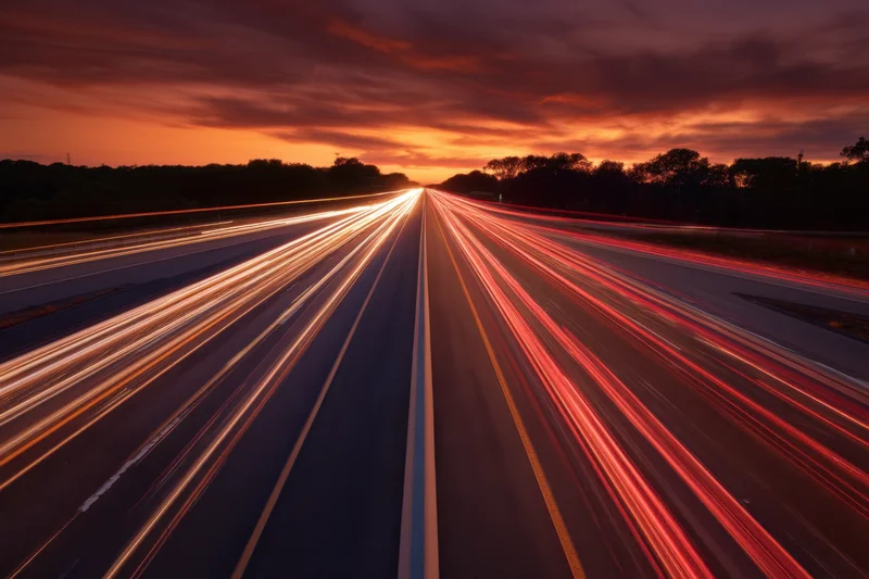 Light trails from vehicles moving on a highway at dusk