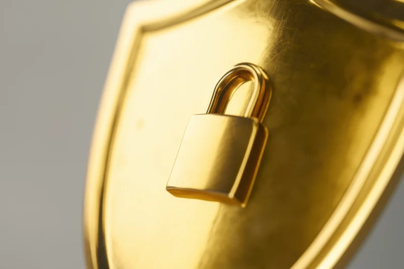 Golden shield with a padlock symbol prominently displayed