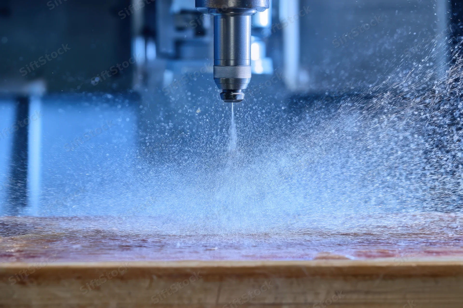 High-pressure waterjet cutting wood in an industrial workshop