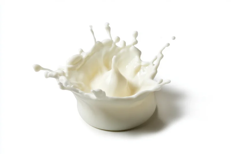 Milk splash forming a crown of droplets in mid-air against white background