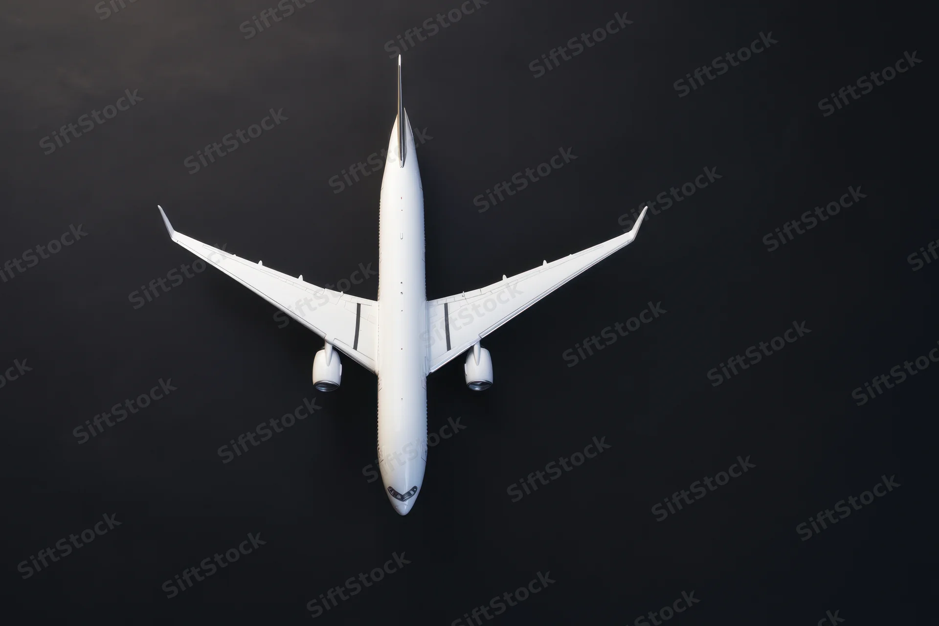 White model airplane viewed from above on matte black surface