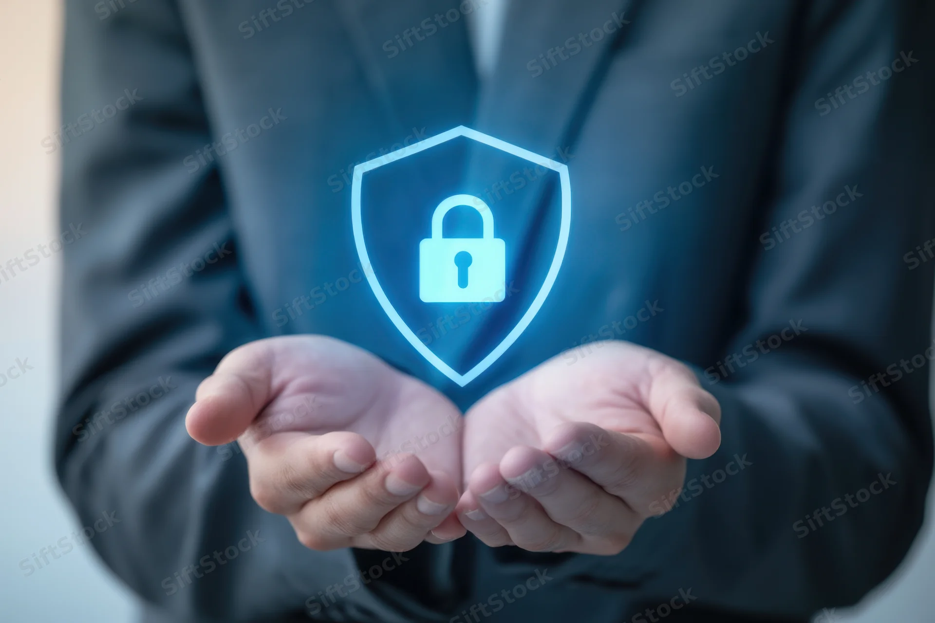 Hands cradling a glowing blue holographic shield with a lock symbol