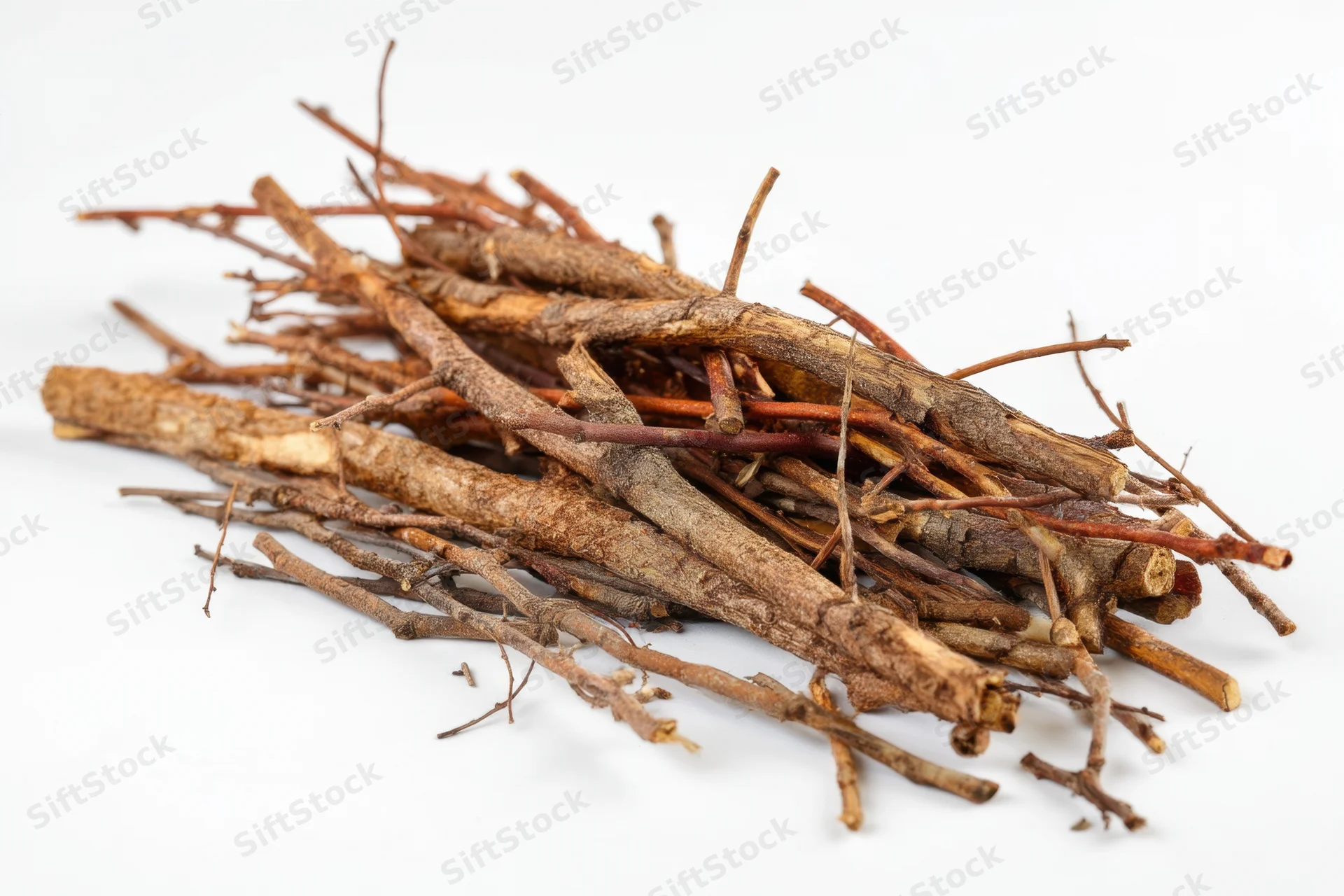 Pile of dried tree branches and twigs arranged on white background
