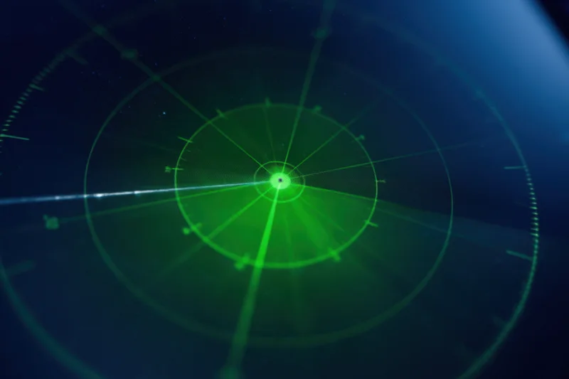 Green radar display with circular interface and concentric rings on dark screen