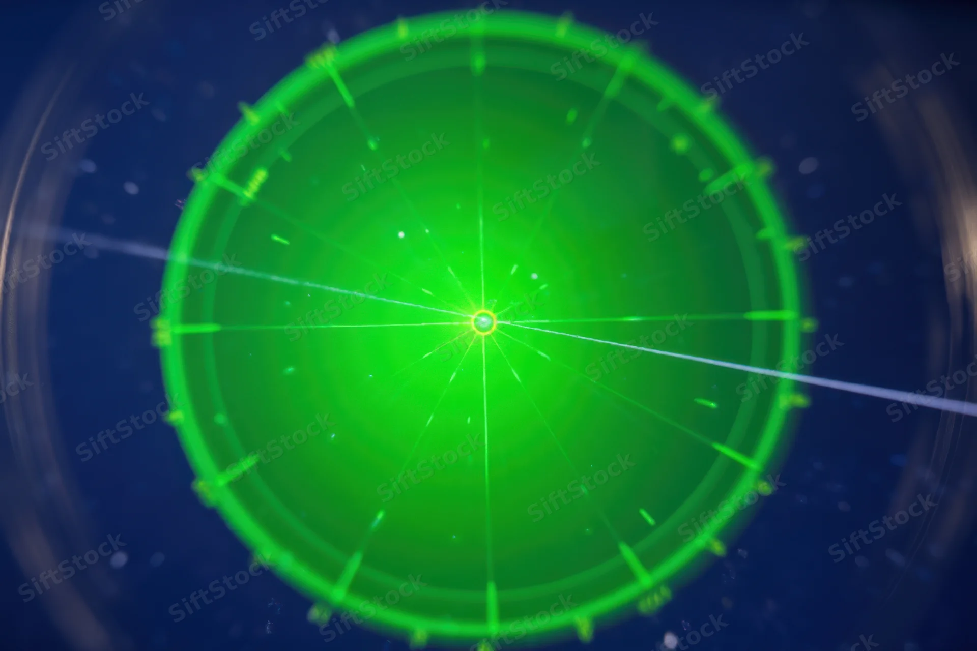 Green circular radar display with glowing center and radial lines on dark background
