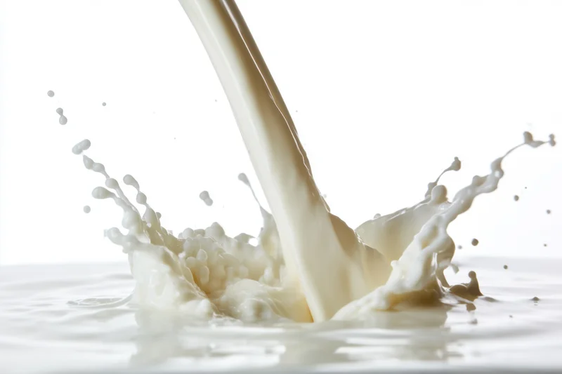 Milk being poured into a pool of milk creating a dynamic splash