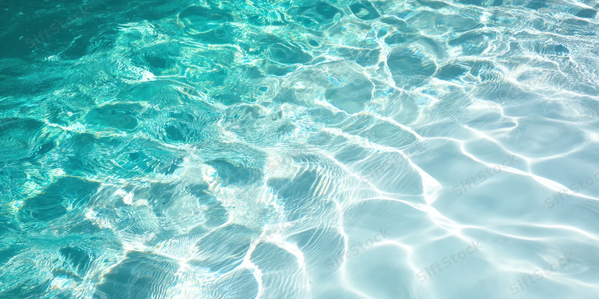 Turquoise pool water with sunlit ripples shimmering on the surface