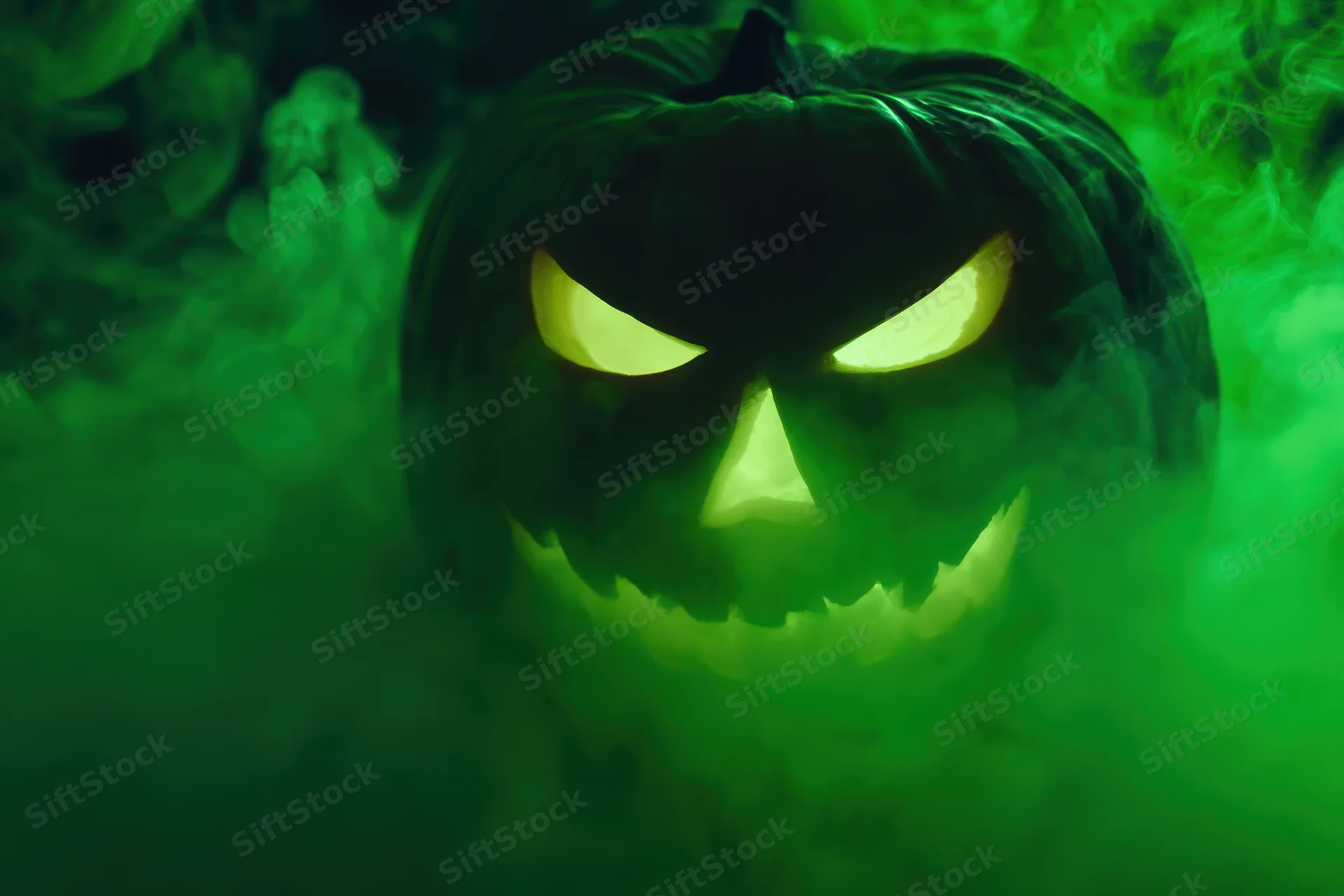 Glowing jack-o-lantern with carved mischievous face in green smoke at night