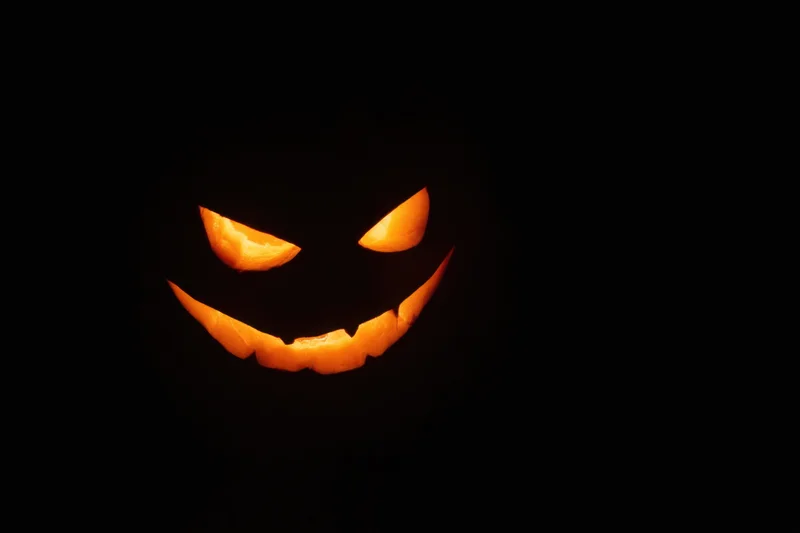 Glowing jack-o-lantern with mischievous grin in dark night