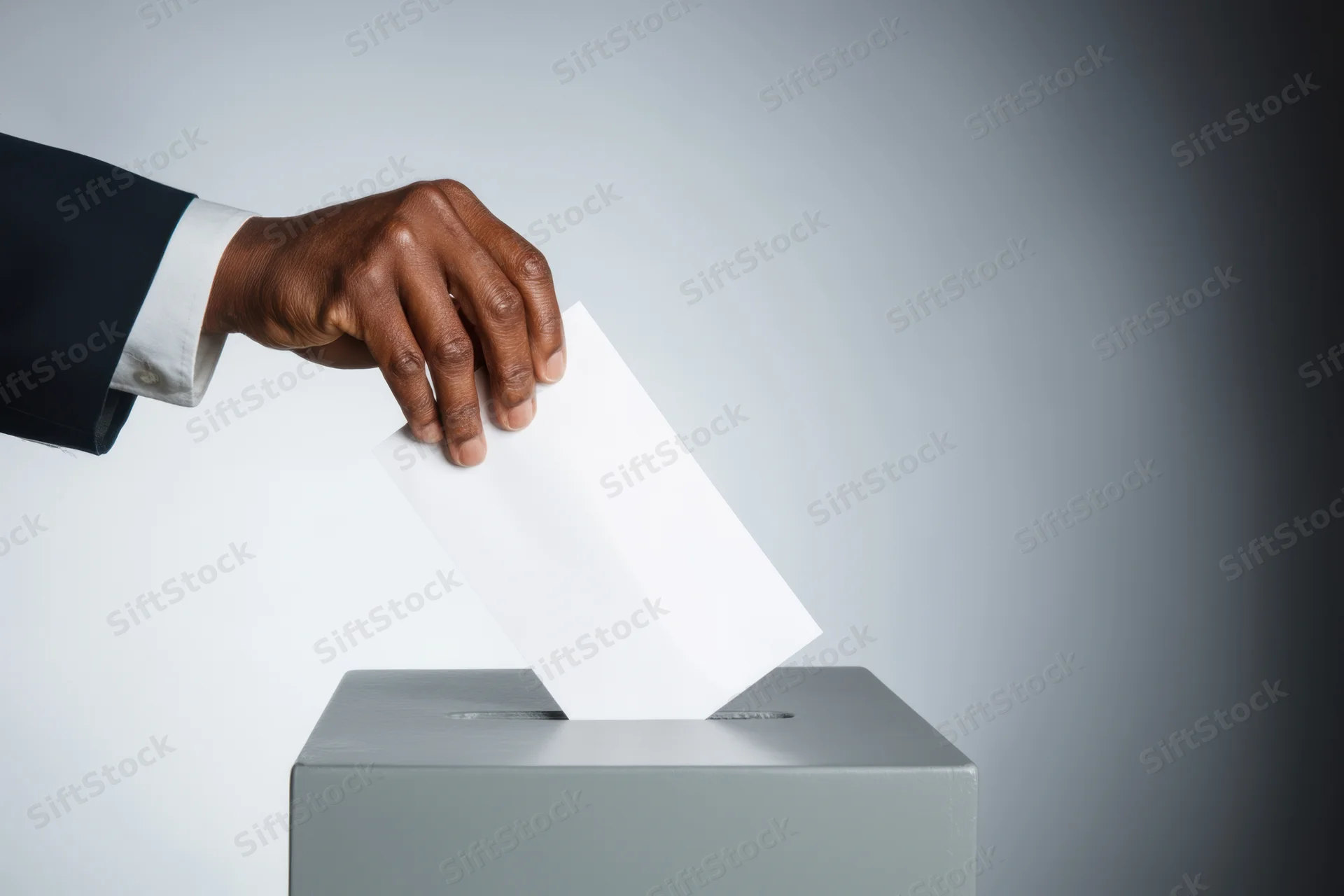 Hand in suit inserting ballot into gray ballot box