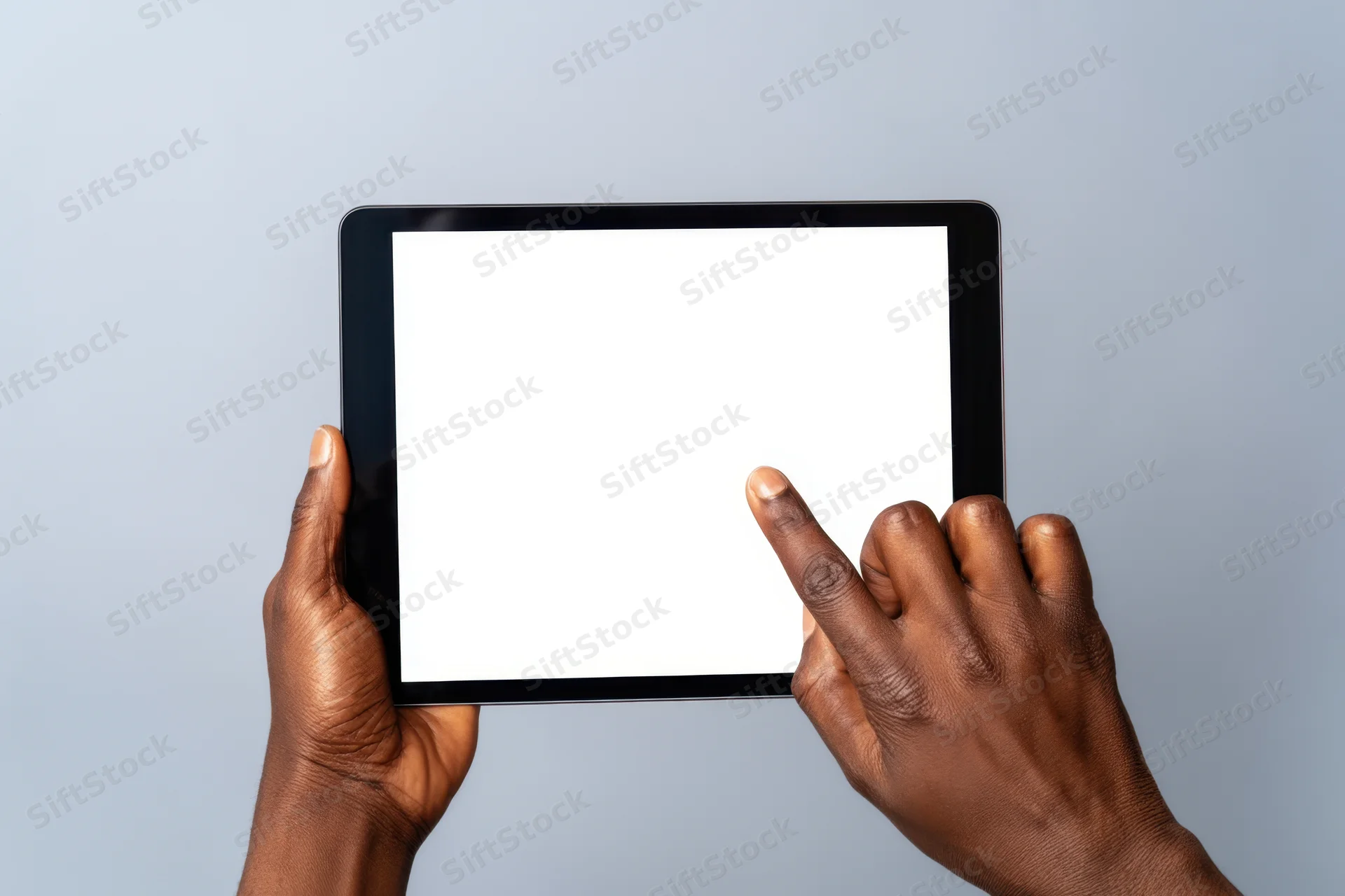 Hands holding tablet with blank screen and finger touching display