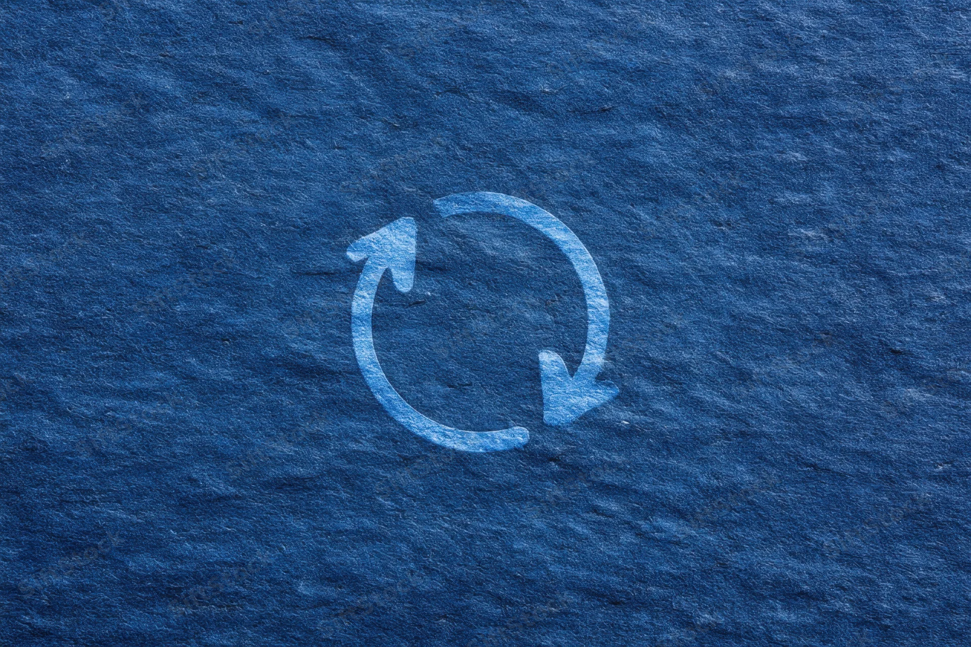 Circular arrows symbol on textured dark blue background