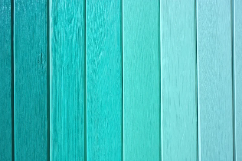 Vertical wooden panels painted in a turquoise to light blue gradient forming a wall surface