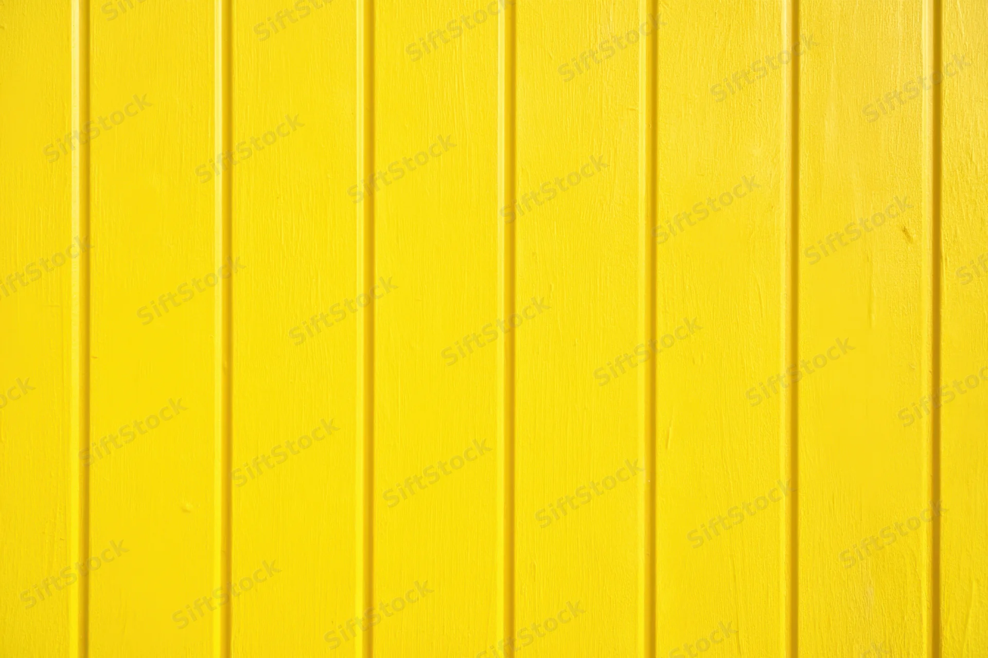Vibrant yellow vertical panels covering an exterior wall