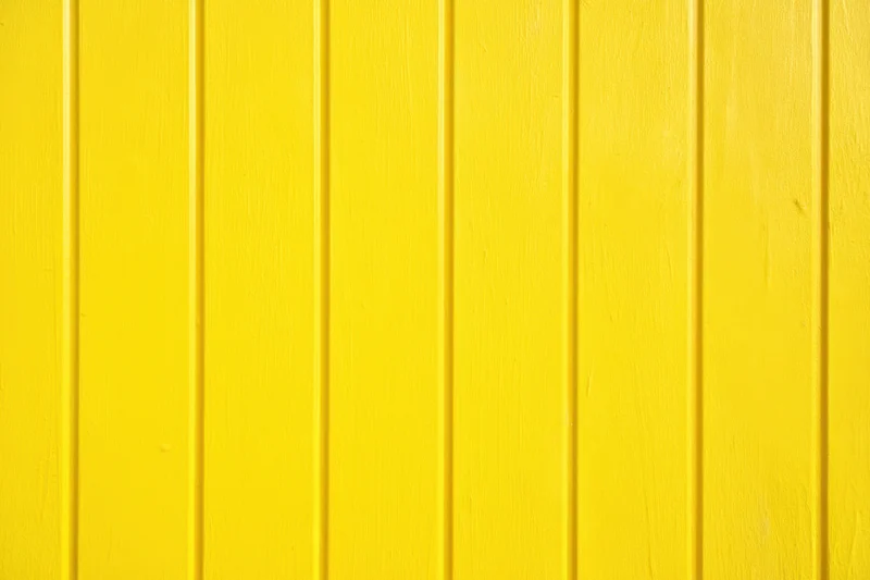 Vibrant yellow vertical panels covering an exterior wall