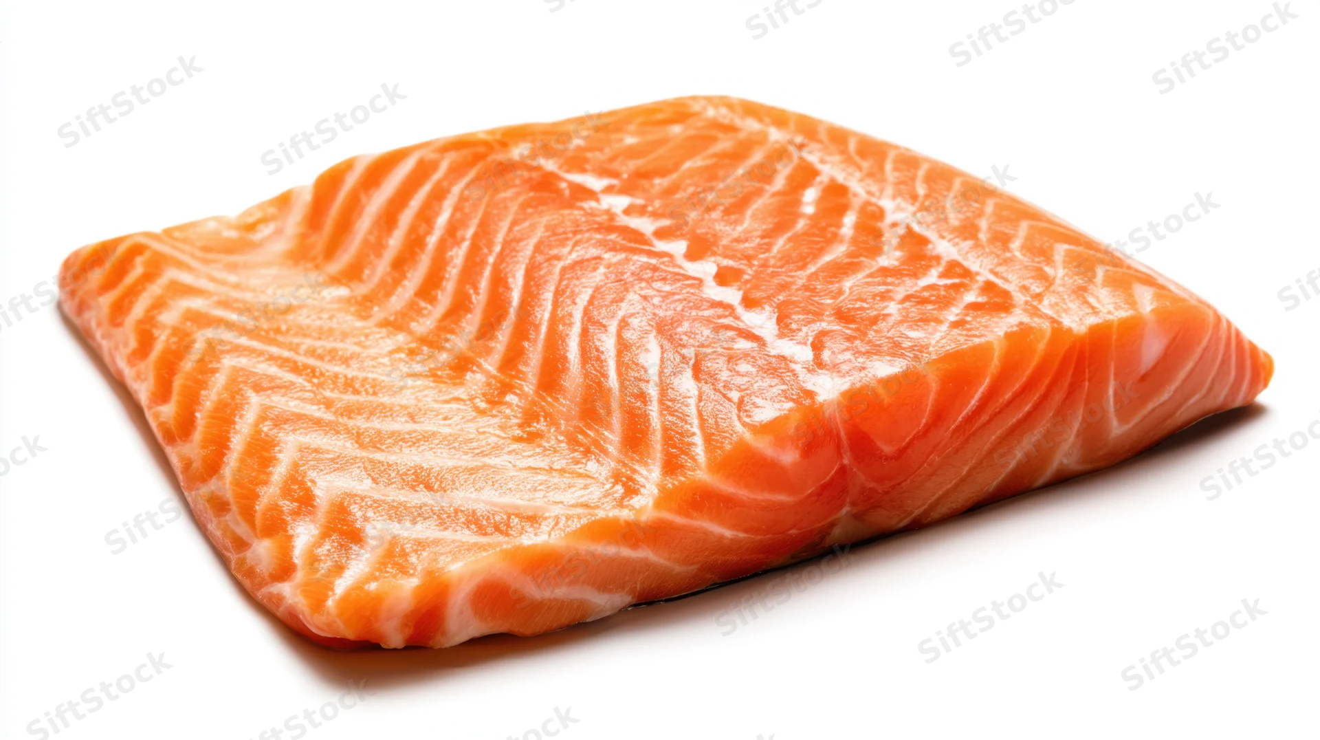 Close-up of a raw salmon fillet with visible marbling on a white background