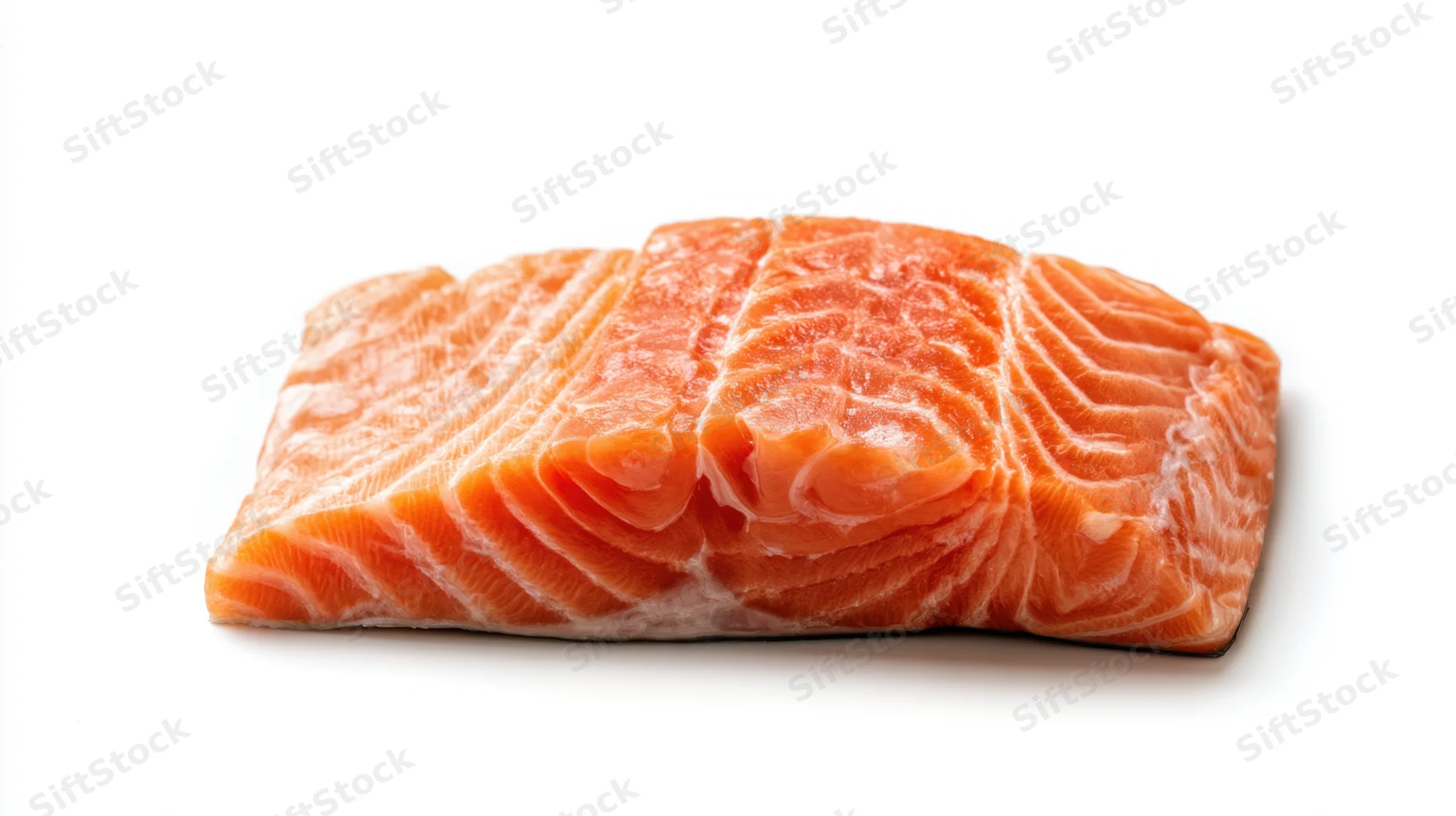 Fresh salmon fillet resting on a clean white surface