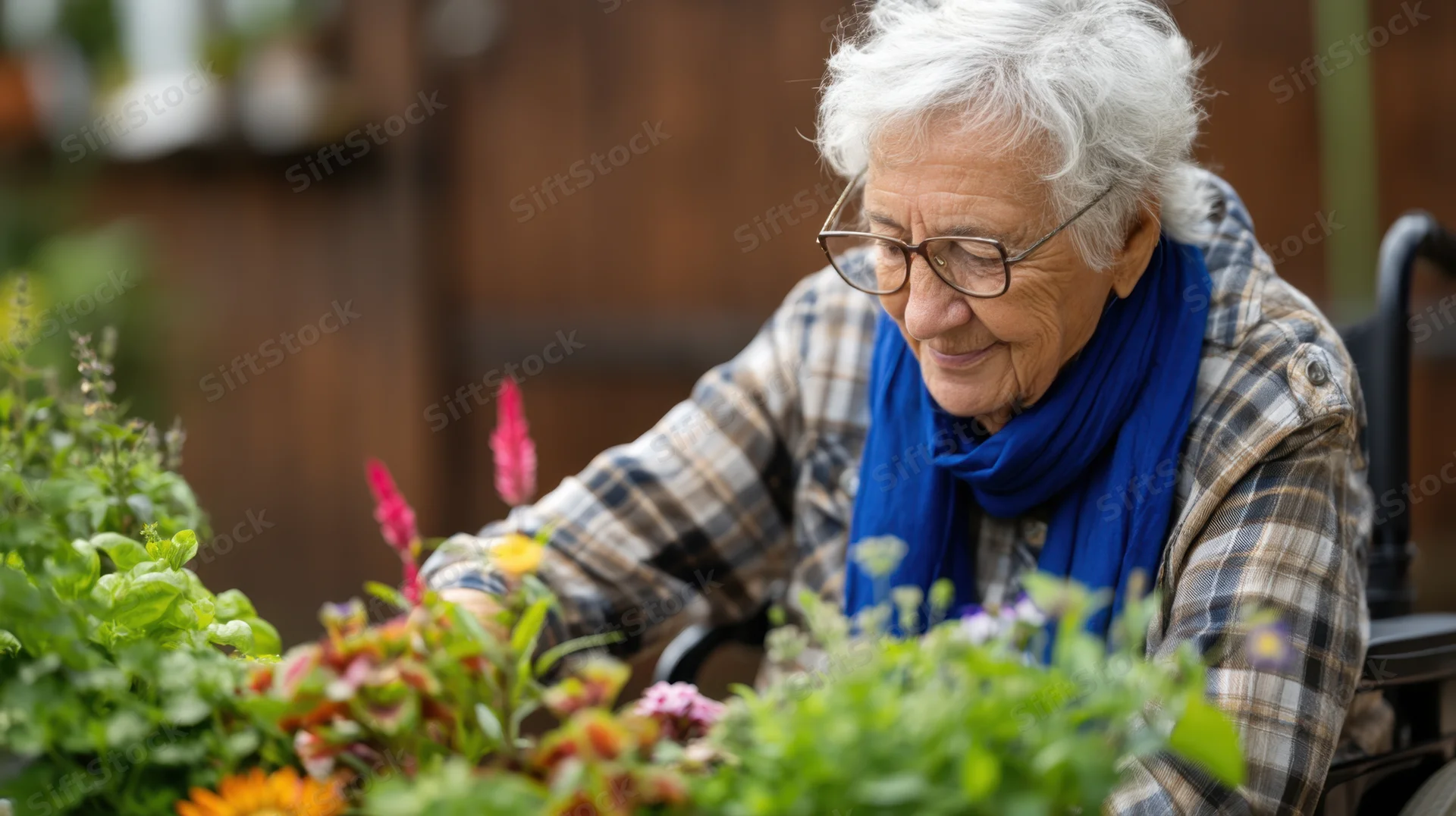 Elderly woman in wheelchair tending vibrant garden outdoors