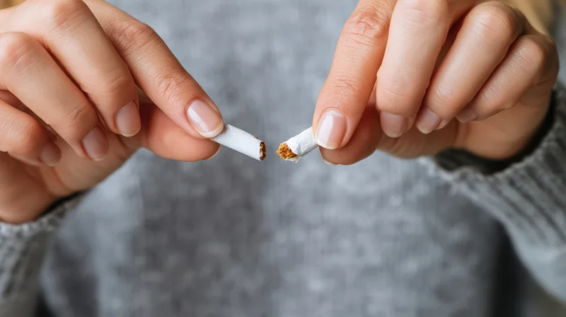 Hands holding broken cigarette halves in close-up view
